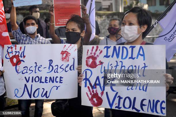 All India Progressive Women's Association activists hold placards and shout slogans during a demonstration against the recent death of a 19-year-old...