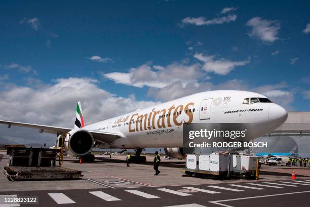 An Emirates aircraft is parked after landing at the Cape Town International airport after flying from Dubai, one of the first international...