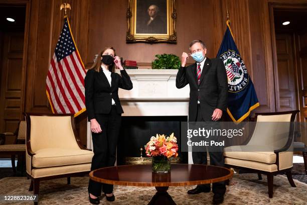 Judge Amy Coney Barrett, President Donald Trump's nominee for Supreme Court, and Senator Steve Daines, R-Mont., pose for a photo before a meeting at...