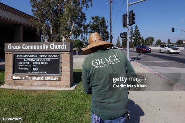 Grounds keeper trips the grass at Grace Community Church on Friday, Sept. 4, 2020 in Sun Valley, CA.