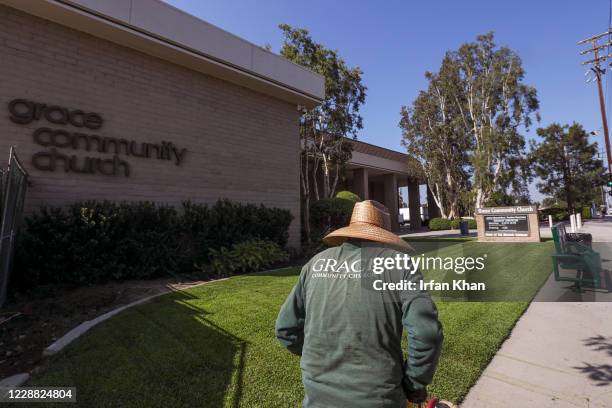 Grounds keeper trips the grass at Grace Community Church on Friday, Sept. 4, 2020 in Sun Valley, CA.