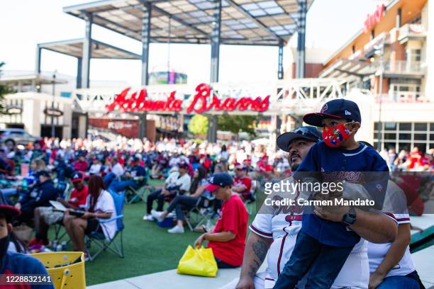 Fans gather inside The Battery Atlanta to watch Game Two of the National League Wild Card Series between the Cincinnati Reds and the Atlanta Braves...