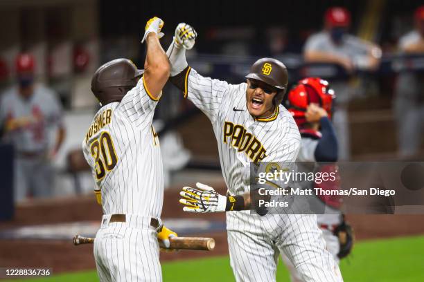 Manny Machado celebrates with Eric Hosmer of the San Diego Padres after hitting a home run in the bottom of the sixth inning against the St Louis...