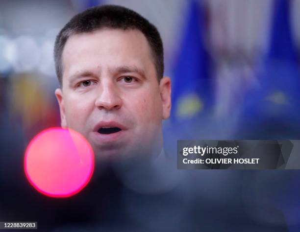 Estonia's Prime Minister Juri Ratas speaks to the press as he arrives on the second day of a European Union summit at The European Council Building...