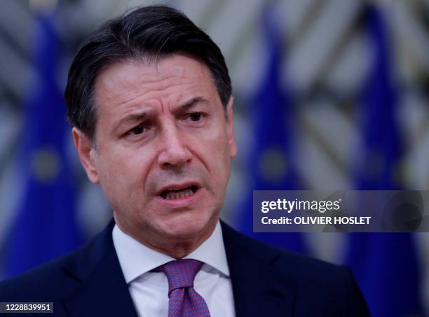 Italian Prime Minister Giuseppe Conte speaks to the press as he arrives on the second day of a European Union summit at The European Council Building...