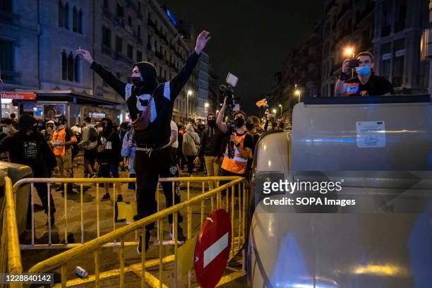 Protester is seen in Plaza Catalunya at the top of a barricade as pro-independence demonstrators marched on the streets of Barcelona.. Summoned by...
