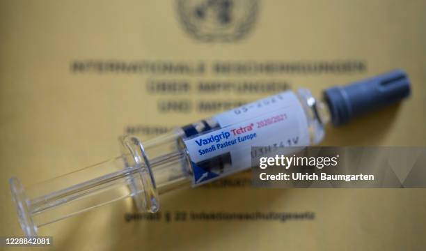 In this photo illustration a Flu vaccine syringe lies on a vaccination certificate on October 02, 2020 in Bonn, Germany.