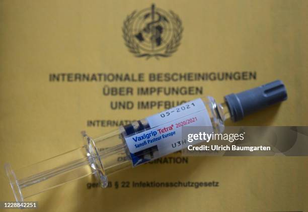 In this photo illustration a Flu vaccine syringe lies on a vaccination certificate on October 02, 2020 in Bonn, Germany.