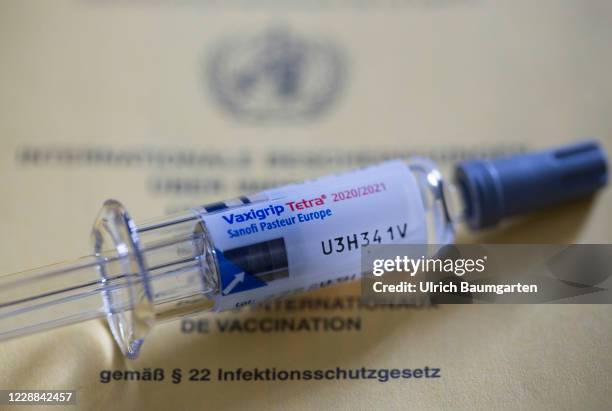 In this photo illustration a Flu vaccine syringe lies on a vaccination certificate on October 02, 2020 in Bonn, Germany.