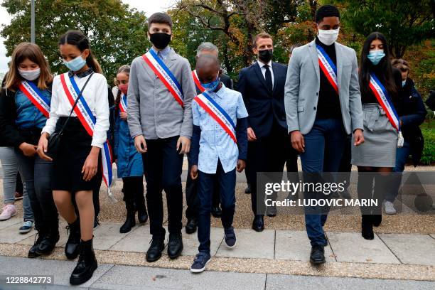 French President Emmanuel Macron wearing a protective face mask arrives at 'la Maison des habitants' to meet and have lunch with young...