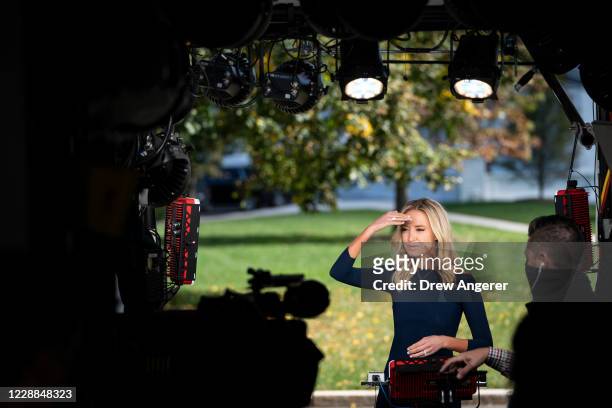 White House Press Secretary Kayleigh McEnany prepares to do a television interview outside the West Wing of the White House on October 2, 2020 in...