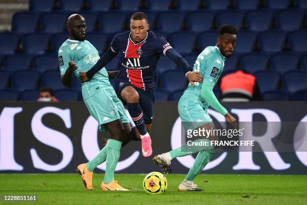 Paris Saint-Germain's French forward Kylian Mbappe breaks through the defence and passes the ball leading to his team's second goal during the French...
