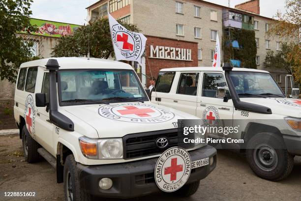 Red Cross vehicles parked in Verkhnotoretske on the frontline outside Donetsk as Ukraine marks Teachers Day on October 2, 2020 in Donetsk, Ukraine....