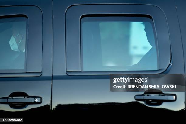 President Donald Trump travels in an armor vehicle with masked members of the Secret Service after arriving at Walter Reed Medical Center October 2...