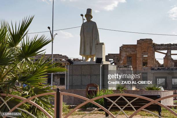 This picture taken on August 23, 2020 shows the statue of Mulla Uthman, a Sufi poet from Iraq's northern city of Mosul, erected in the centre of a...