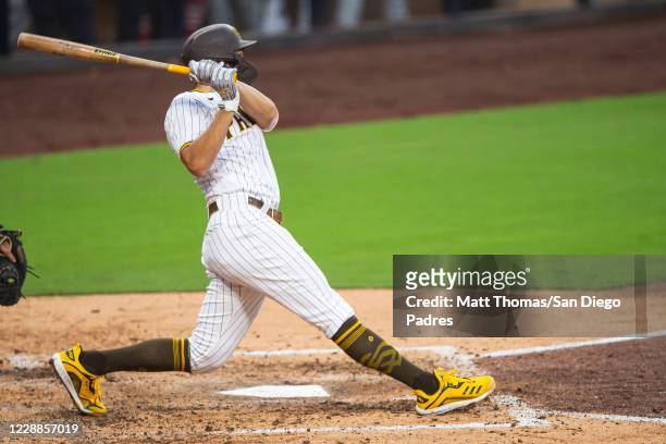 Eric Hosmer of the San Diego Padres swings and hits a RBI double in the bottom of the fifth inning against the St Louis Cardinals during Game Three...