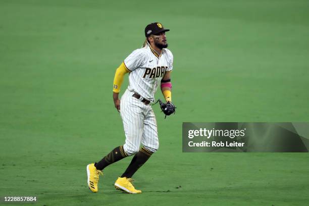 Fernando Tatis Jr. #23 of the San Diego Padres reacts to making a diving catch in the eighth inning during Game 3 of the Wild Card Series between the...