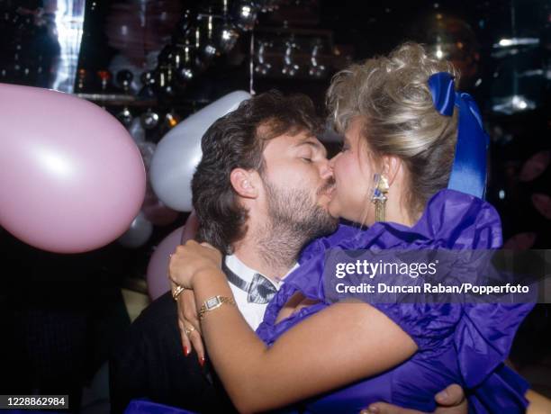British glamour model and singer Samantha Fox kissing her boyfriend Peter Foster at her 21st birthday party in London, England on 15 April, 1987.