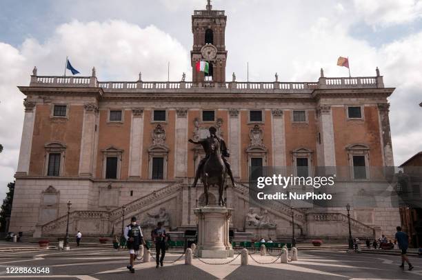 People wearing a mask to protect themselves from COVID-19 passes in front of Piazza del Campidoglio in Rome, on October 2, 2020. The Italian Prime...