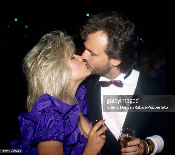 British glamour model and singer Samantha Fox kissing her boyfriend Peter Foster at The Berkeley Square Ball in London, England on 6 July, 1987.