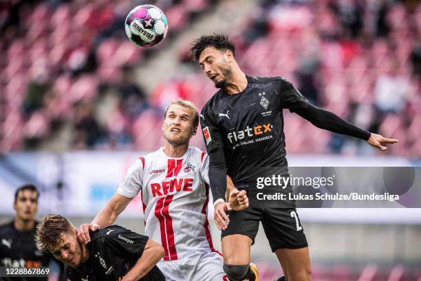 Sebastian Andersson of Köln and Ramy Bensebaini of Mönchengladbach in action during the Bundesliga match between 1. FC Köln and Borussia...