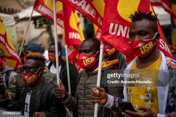 Migrants and refugees from Africa holding flags demonstrate against Italian government and immigration policies as part of the National Day in...