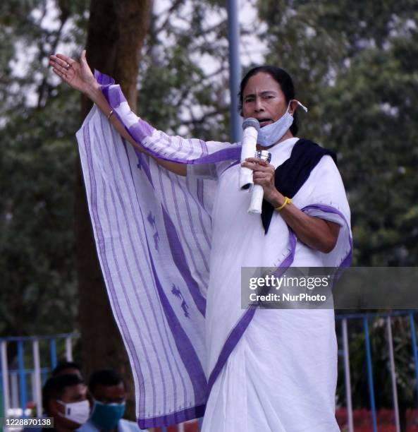 West Bengal Chief Minister Mamata Banerjee deliver her speech during a protest rally against the death of a 19-year-old Dalit woman who was allegedly...