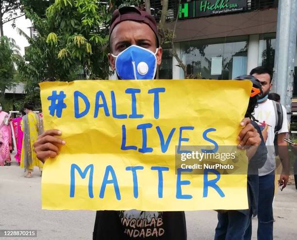 Activists hold placards during a protest over the death of a 19-year-old Dalit woman after an alleged gangrape in UPs Hathras, in Guwahati, Assam,...