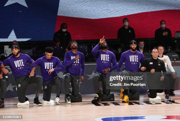 JaVale McGee, Danny Green, Kentavious Caldwell-Pope, LeBron James, Anthony Davis and Frank Vogel of the Los Angeles Lakers during the National Anthem...
