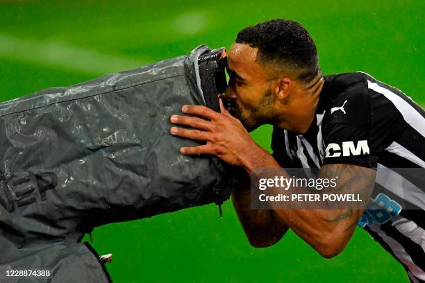 Newcastle United's English striker Callum Wilson celebrates scoring his team's third goal by kissing the television camera during the English Premier...