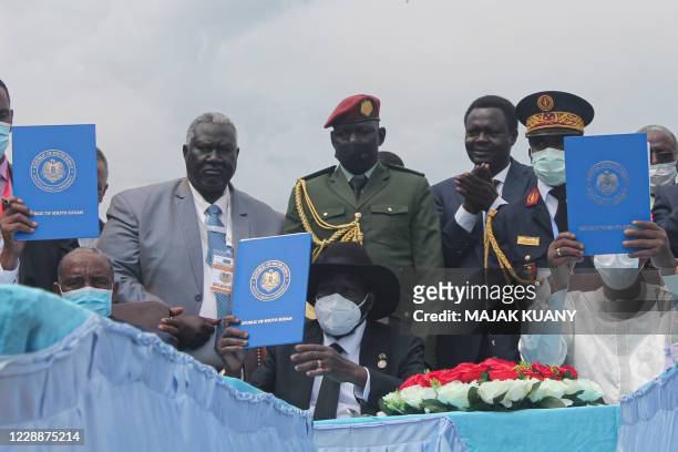 Chairman of Sudan's Sovereign Council Abdel Fattah al-Burhan , South Sudan's President Salva Kiir and Chadian President Idriss Deby hold a copy of...