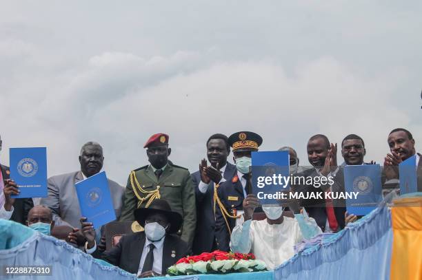 Chairman of Sudan's Sovereign Council Abdel Fattah al-Burhan , South Sudan's President Salva Kiir and Chadian President Idriss Deby hold a copy of...