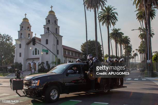 Police officers follow a group of Black Lifes Matter demonstrators who were protesting in front of a pro-Trump rally in Beverly Hills, California on...
