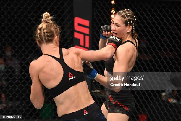 In this handout image provided by UFC, Irene Aldana of Mexico punches Holly Holm in their women's bantamweight bout during the UFC Fight Night event...