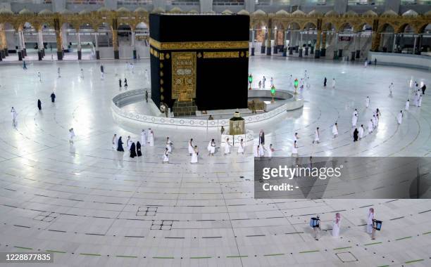 Saudis and foreign residents circumambulate the Kaaba in the Grand Mosque complex in the holy city of Mecca, on October 4 as authorities partially...