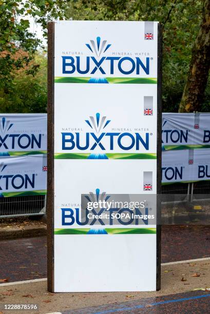 Buxton sponsorship sign seen on the route of the 40th London Marathon. Only Elite runners will run the course this year with everyone else taking...