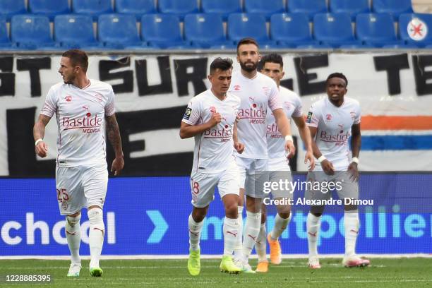 Team of Nimes celebrates his scoring during the Ligue 1 match between Montpellier HSC and Nimes Olympique at Stade de la Mosson on October 4, 2020 in...