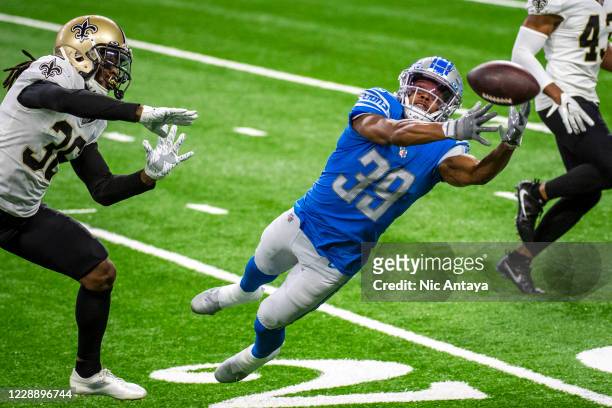 Jamal Agnew of the Detroit Lions misses a catch while being covered by D.J. Swearinger of the New Orleans Saints during the second quarter at Ford...