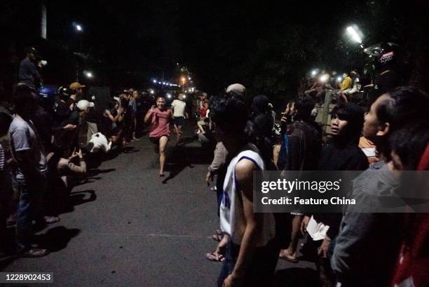 People watch an illegal sprint race in Cibinong area, Bogor Regency, West Java, after midnight Saturday, Sept. 12, 2020. Despite of being an unlawful...