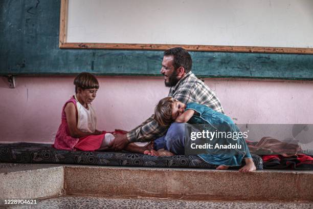 Year-old Meryem Es-Sah with a severe skin disease "Pemphigus" since she was 3-month old is seen with her father in Idlib, Syria on September 24,...