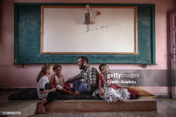Year-old Meryem Es-Sah with a severe skin disease "Pemphigus" since she was 3-month old is seen with her siblings and father in Idlib, Syria on...