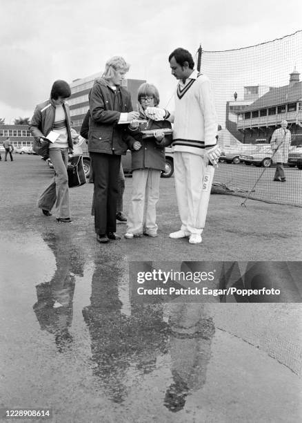 India's captain Ajit Wadekar signing autographs for young fans as rain delays the start of day three of the 1st Test match between England and India...