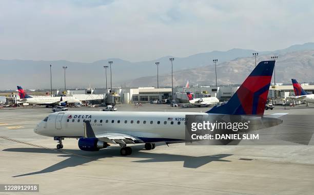 Delta Airlines plane is seen at the gate at Salt Lake City International Airport , Utah, on October 5, 2020.