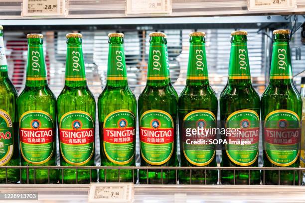 Bottles of Tsingtao beer seen displayed for sale in a supermarket.