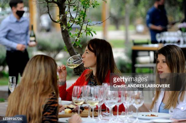 Woman tastes wine at Argentinian agronomist and winemaker Alejandro Vigil's Casa Vigil winery, restaurant and art space, in Chachingo, Maipu...