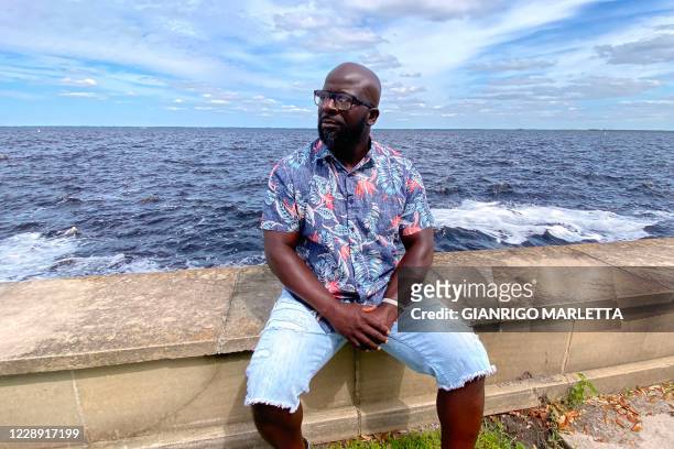 Davion Hampton poses as he sits by Lake Monroe in Sanford on the outskirts of Orlando, Florida on September 30, 2020. - Davion and Maria, two former...