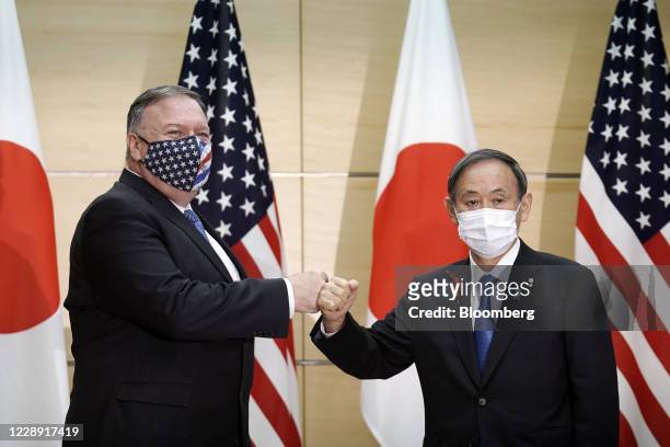 Michael Pompeo, U.S. Secretary of State, left, and Yoshihide Suga, Japan's prime minister, pose for a photograph prior to a meeting at the prime...
