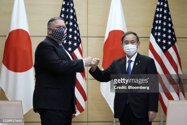 Michael Pompeo, U.S. Secretary of State, left, and Yoshihide Suga, Japan's prime minister, pose for a photograph prior to a meeting at the prime...