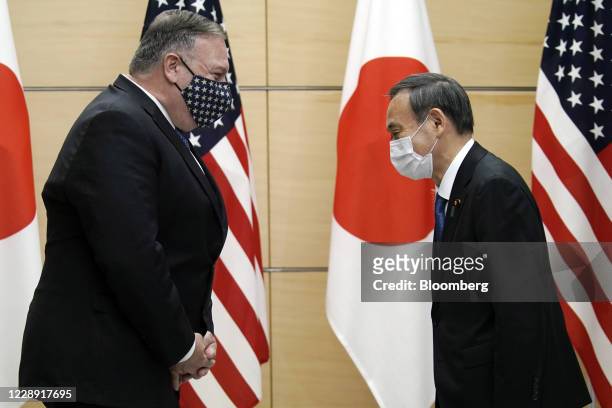 Michael Pompeo, U.S. Secretary of State, left, greets with Yoshihide Suga, Japan's prime minister, prior to a meeting at the prime minister's office...