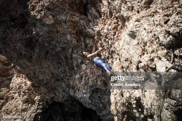 Climber climbs a rock before falling the sea in "Suluada" which is located 7 kilometers from Cape Gelidonya and the favorite spot location for deep...